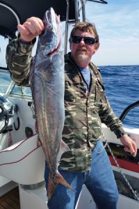 Lockie Wombell with a good size gemfish taken offshore from Portland (Picture: Bob McPherson).