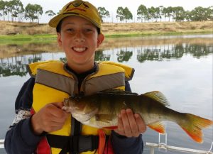 Lachlan Grove with his Monday morning’s redfin from Lake Purrumbete (Picture John Clements). .