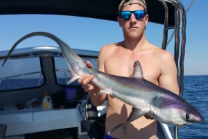 Cameron Habgood with his thresher shark prior to release (Picture: Aaron Habgood).