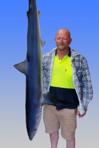 Matt Tattersall with a blue shark that he and Justin Latter caught offshore from Barwon Heads last week.