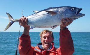 Travel Oz presenter Greg Grainger looks pleased with the bluefin tuna he caught while out with Bob McPherson off Portland (Picture: Bob McPherson).