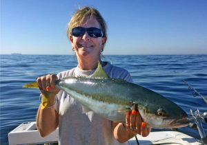 Linda Stewart with the kingfish she caught offshore from Black Rock on Sunday (Picture: Murray Stewart).