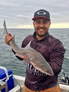 Adam Nikolovski with a gummy shark that he caught off St Leonards (Picture: Renae Ciuffetelli).