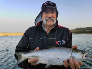 Well taken: Cricket legend Merv Hughes with a nice chinook salmon from Lake Bullen Merri (Picture: Victorian Inland Charters).   