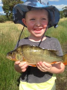 Three year old Murray Booth with the redfin he caught on a Celta lure while fishing with his father Ryan at Queens Park on the Barwon River on Saturday.