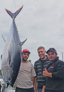 Chris Mifsud, Darren McMahon and Andrew Scilluna with the 68 kg tuna that they caught offshore from Portland (Picture: Bob McPherson).