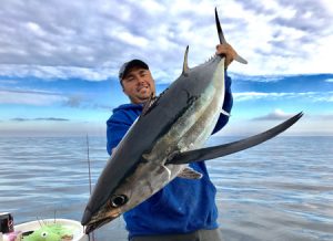 Cole Sheppard with a 15 kg albacore he caught offshore from Lakes Entrance (Picture: Kevin McLoughlin).