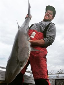 Jake Donaldson with a school shark that he caught last week (Picture:  Sam Donaldson).