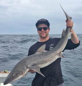 Sam Donaldson with a Gummy shark that they caught at Kangaroo Island last week (Picture: Jake Donaldson).