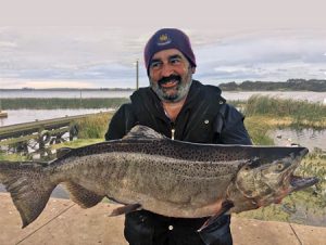 Anthony Webb with the chinook salmon he caught from Lake Purrumbete