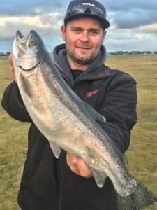 Over the rainbow: Michael Evans with a large rainbow trout that he caught at Wurdiboluc Reservoir last week (Picture: Michael Evans).