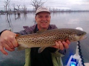 Anthony Forster of Fisheries Victoria with a brown trout from Lake Toolondo (Picture: Victorian Inland Charters).