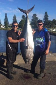 Alex Mordaunt (left) with the 72.5 kg tuna he caught aboard Sharkman Charters (Picture: Bob McPherson).