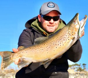 Michael Evans with a 61 cm brown trout that he caught from Wurdiboluc Reservoir on a bibbed minnow (Picture: Michael Evans).