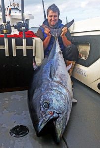 Adrian Ryan with the 104 kg tuna that he and Greg Ruder caught off Cape Nelson on Friday (Picture: Bob McPherson).