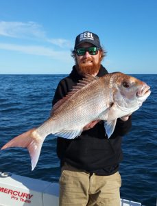 Aaron Habgood with one of the snapper he caught offshore from Barwon Heads (Picture: Lee Rayner).