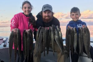 Alana and Adam Vasilevski with Aaron Habgood (centre) with their catch of whiting.