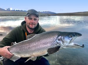 Michael Evans with a 7.7 kg brown trout from the Twizel Canals in New Zealand.