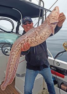 Michael Goldby with a pink eel that he caught offshore from Portland over the weekend (Picture Bob McPherson).   