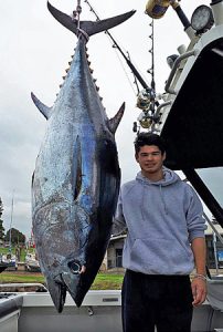 Nigel Ah-Cann with his 125 kg tuna, also taken offshore from Portland (Picture: Bob McPherson).