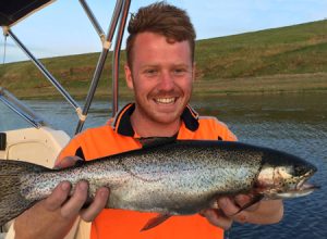 Jayden Wright with a rainbow trout that he caught from Lake Bullen Merri (Picture: Lake Purrumbete Holiday Park).   