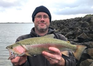 Simon Williams with the rainbow trout he caught from Wurdiboluc Reservoir (Picture: Justin Burns).