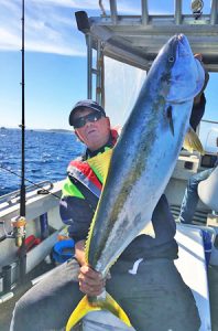 Scott Teesdale with one of the kingfish he caught off Port Phillip Heads on Friday.