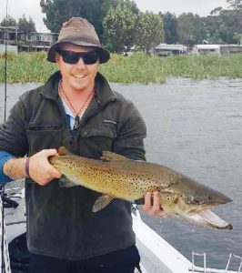 Todd Broughton of Bannockburn with a 93 cm brown trout from Purrumbete which he released (Picture: Courtesy of Lake Purrumbete Holiday Park).