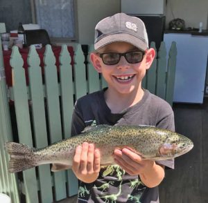 Josh White with a rainbow trout just over a kilogram from Purrumbete (Picture: Courtesy of Lake Purrumbete Holiday Park).