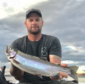 Michael Evans of Victorian Inland Charters with a rainbow trout from Lake Purrumbete.   