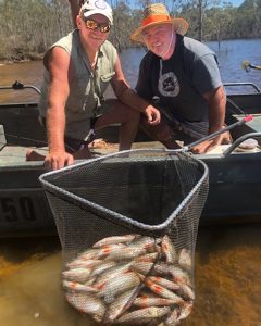 Trevor Holmes of Victorian Inland Charters, and John Clements of Lake Purrumbete Holiday Park, with a good catch of redfin from Rocklands Reservoir (Picture: Victorian Fisheries Authority).   