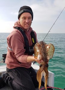 Justin Burns with one of the squid he caught at Queenscliff over the weekend (Picture: Katryna Burns)   