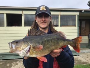 Ben Butcher from Ballarat with a 45 cm redfin that he caught from Lake Toolondo on Saturday evening (Picture: Victorian Inland Charters).   