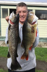 Zac Pritchard of Ballarat with a brown trout and redfin he caught from Lake Toolondo (Picture: Victorian Inland Charters.