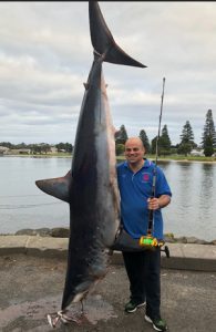 Grazio Dalli with the 250 kg mako shark he caught offshore from Portland on Sunday (Picture: Jason Debrincat).