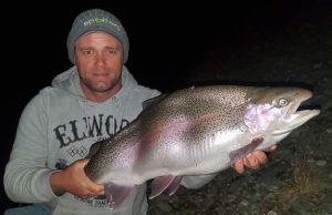 Michael Evans with a somewhat deformed rainbow trout from Tekapo that he caught after dark following their arrival.